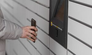 How secure are smart lockers? Article by Brynka featuring young man signing into security features of a smart locker