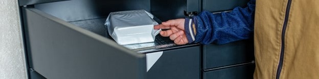 Man placing package for work employee in business smart locker for pickup later