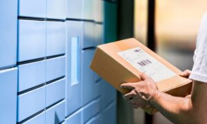 Smart Locker Systems for Businesses banner featuring young man carrying mail package to employee smart locker for pickup