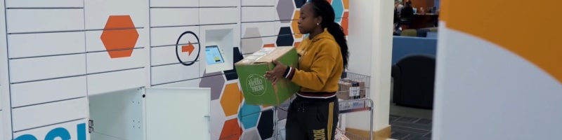 Young girl adding school package to a smart locker for university