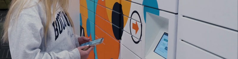 Girl at college smart locker retrieving packaging using smart phone device